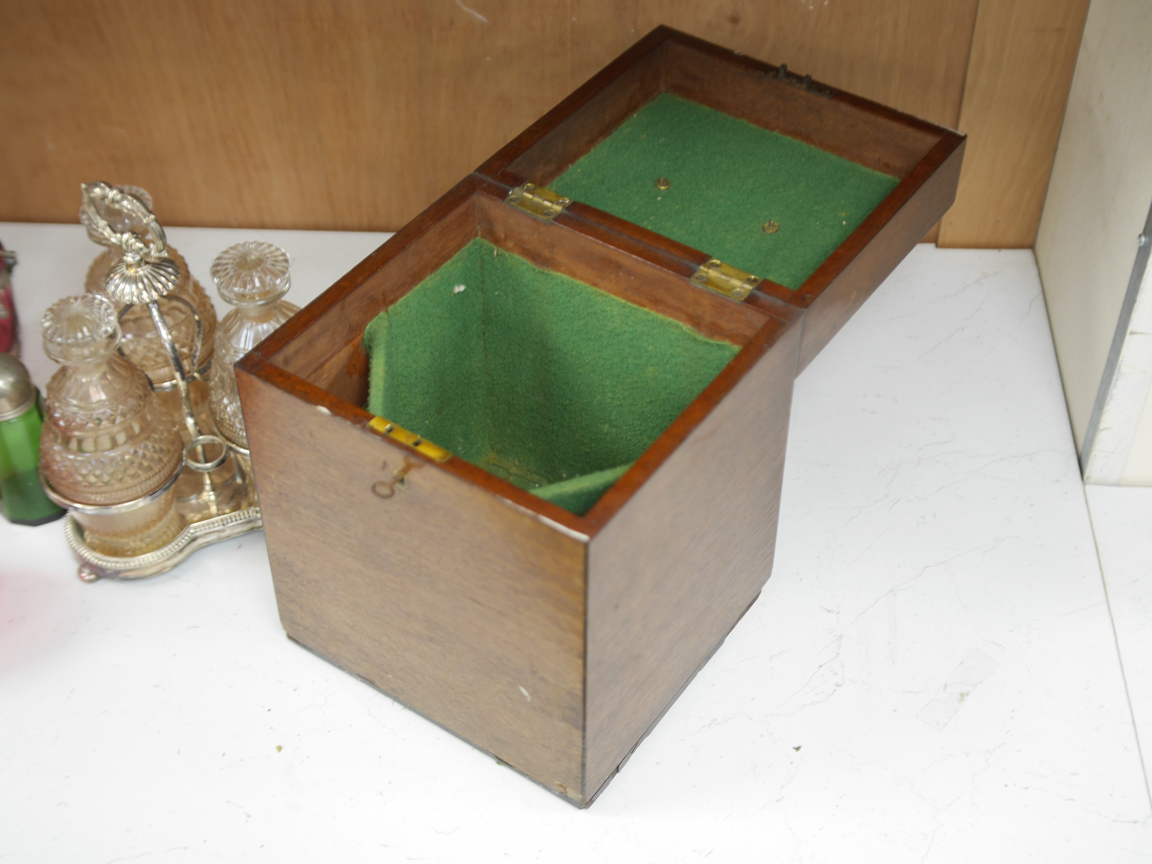 A cased silver plated three bottle liqueur stand, a cranberry decanter, sugar shaker and jam stand together with a green glass shaker, stand 27cm high (5). Condition - all items in good condition, box in need of a clean